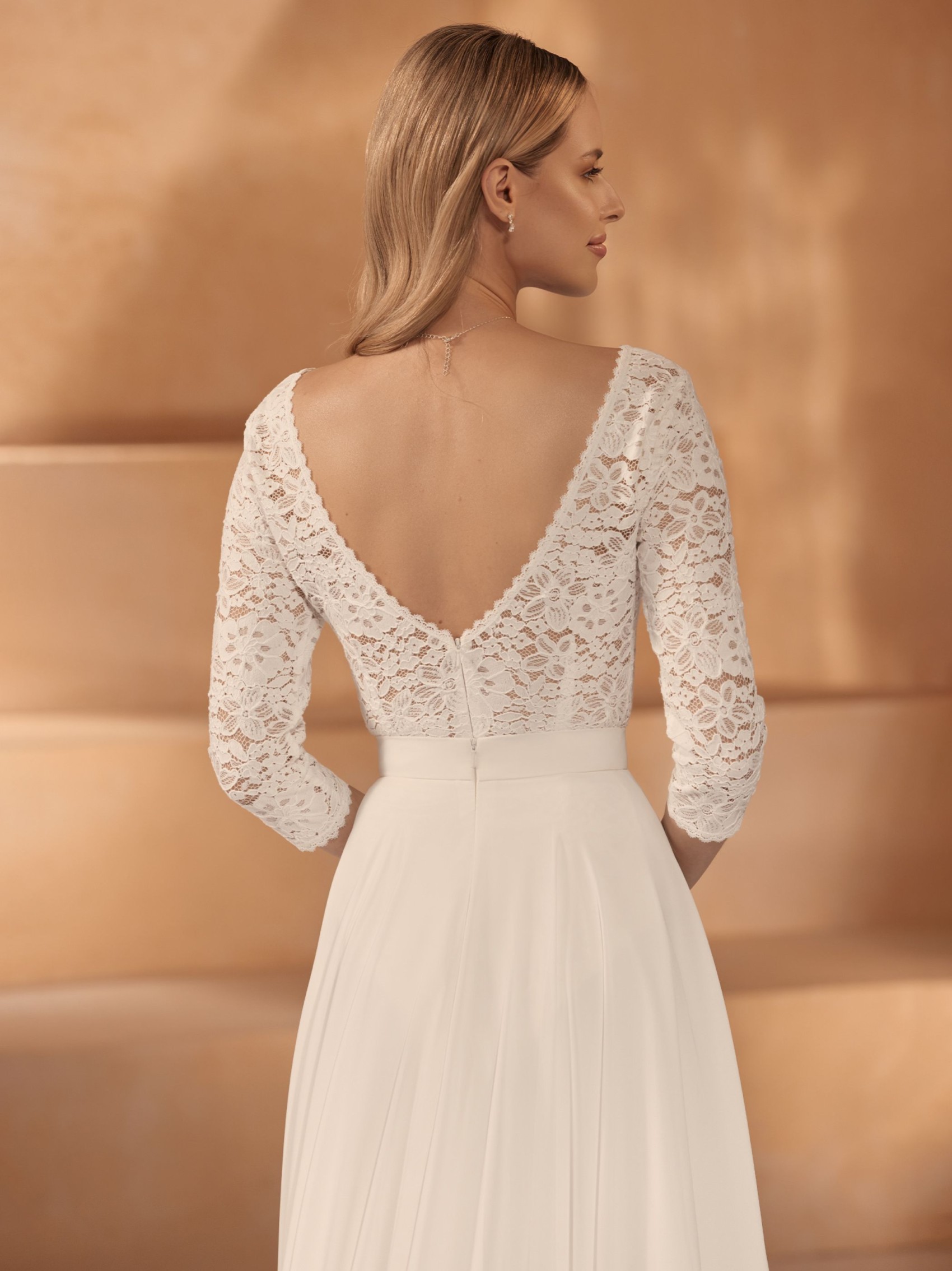 Lace bridal bodysuit with long sleeves and low back combined with