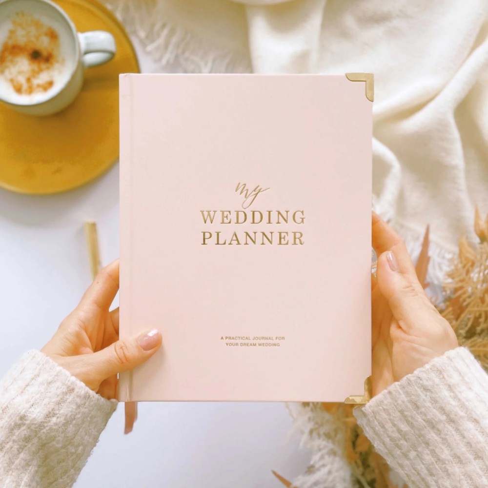 Photograph of Blush and Gold Luxury Wedding Planner Book with Gilded Edges