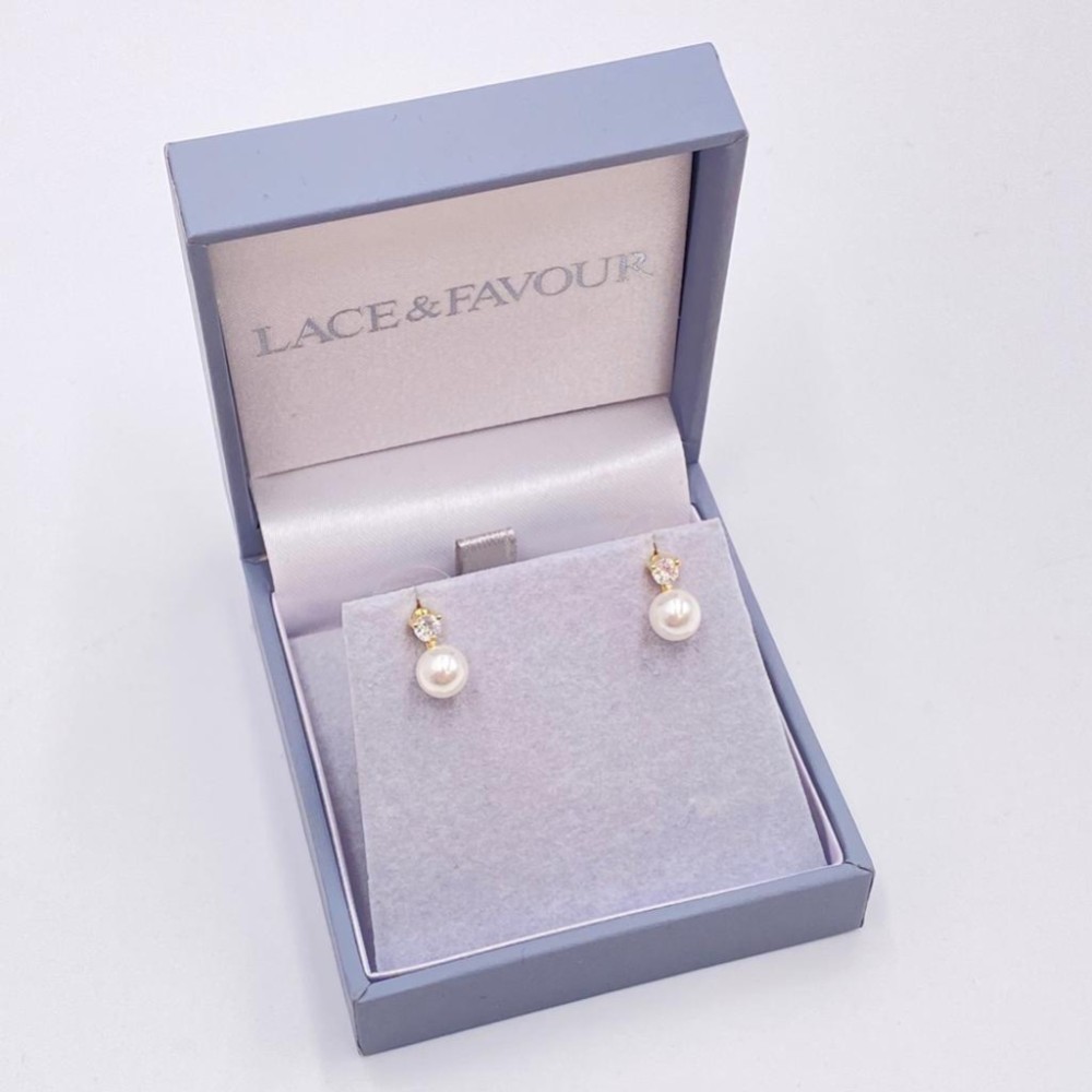 Photograph of Evie Gold Dainty Pearl Stud Earrings