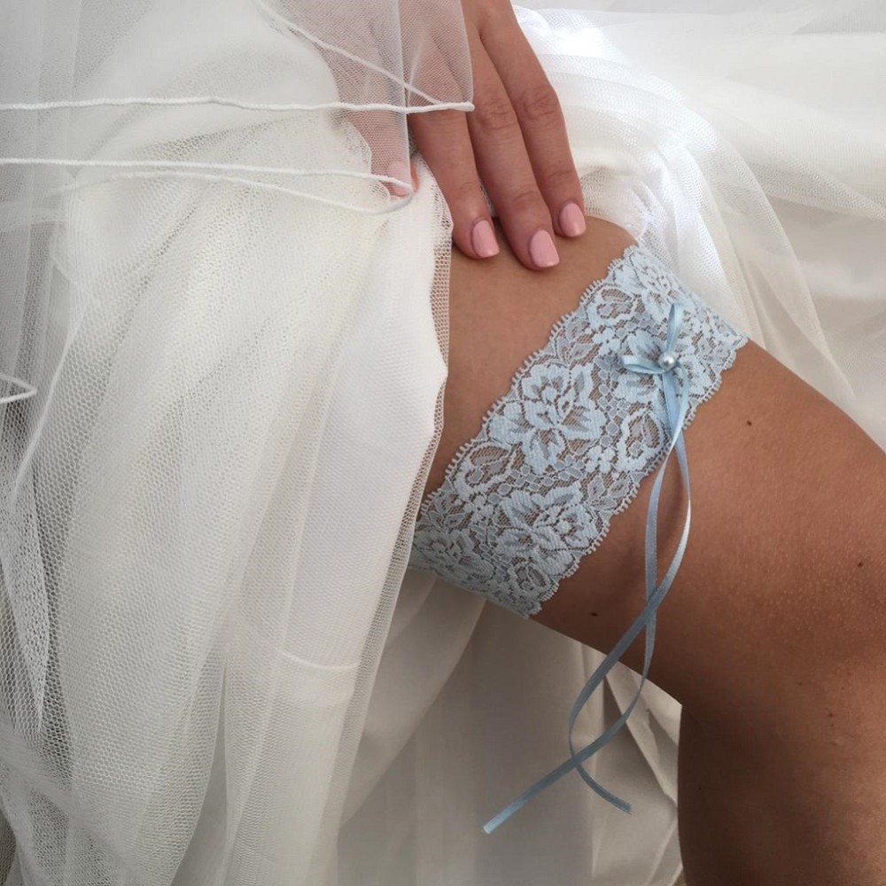 Photograph of Purity Blue Delicate Lace Wedding Garter with Pearl Detail
