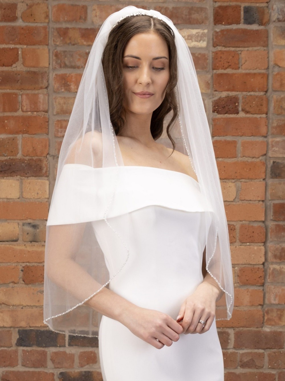 Photograph of Perfect Bridal Ivory Single Tier Pearl and Crystal Edge Fingertip Veil