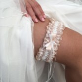 Photograph: Liberty Blush and Ivory Lace Frill Bridal Garter with Double Bow