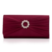 Photograph: Perfect Bridal Harlow Berry Satin Pearl Brooch Clutch Bag