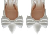 Photograph: Rainbow Club Alice Ivory Satin Oversized Bow Shoe Clips (pinces à chaussures à nœud surdimensionné)